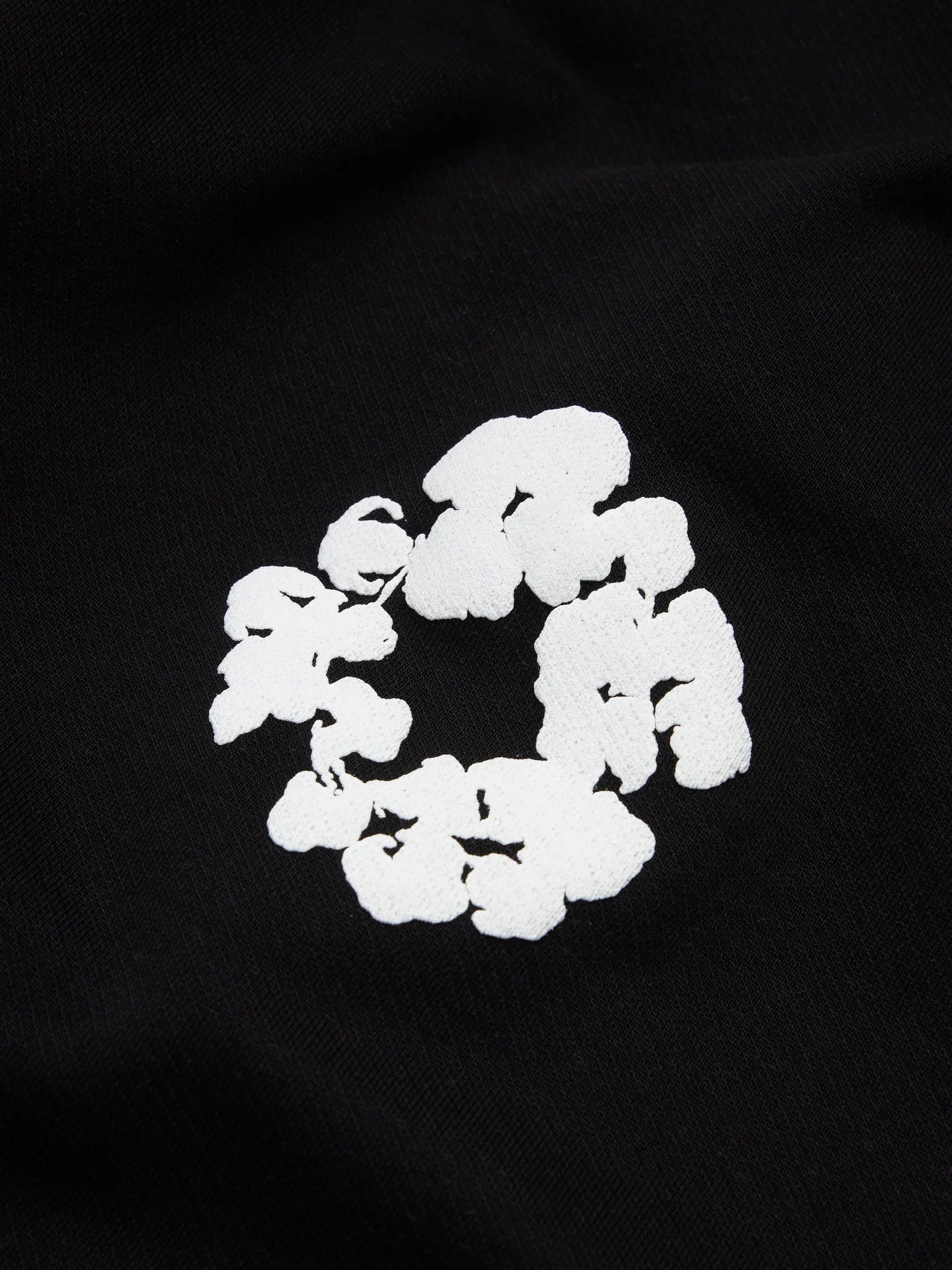 Denim Tears Cotton Wreath Black White Bottoms - close-up fabric and branding detail