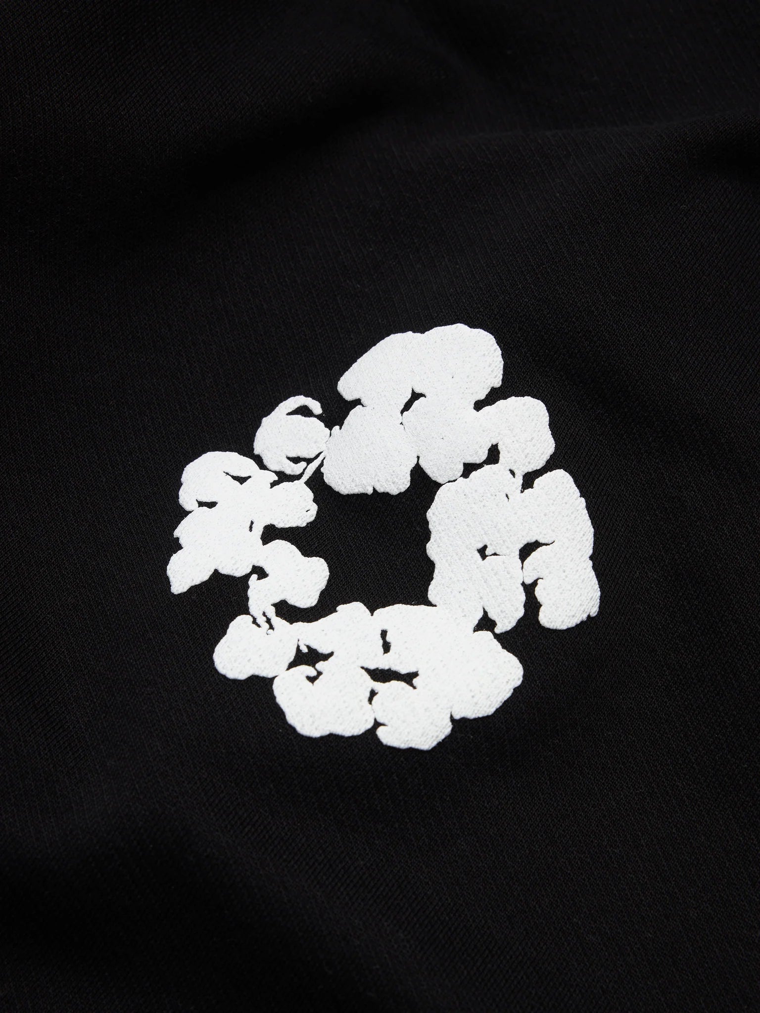 Denim Tears Cotton Wreath Black White Bottoms - close-up fabric and branding detail