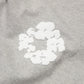 Denim Tears Cotton Wreath Grey Bottoms - close-up fabric and branding detail