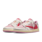 Pair of Travis Scott Air Jordan 1 Low Tropical Pink sneakers showing full design and colorway